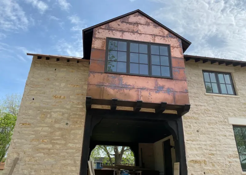 Copper metal panel facade on a stone building for Skylight Installation in Dove Valley